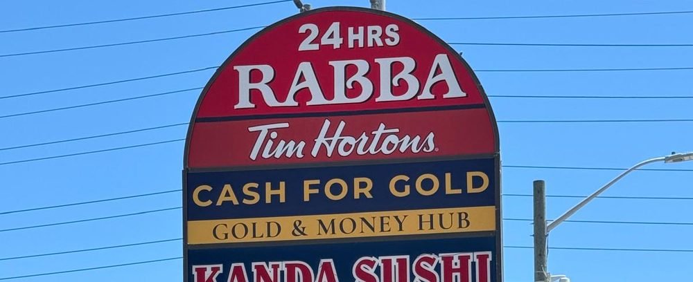 Gold & Money Hub on the plaza sign on Hurontario St in Mississauga, alongside Rabba and Tim Hortons